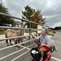Ascension Living Via Christi Village Manhattan Senior Living in Manhattan, Kansas resident in a wheelchair at the petting zoo