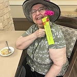 The Village at Keizer Ridge Assisted Living and Memory Care smiling resident with May Day suprise