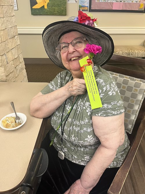 The Village at Keizer Ridge Assisted Living and Memory Care smiling resident with May Day suprise