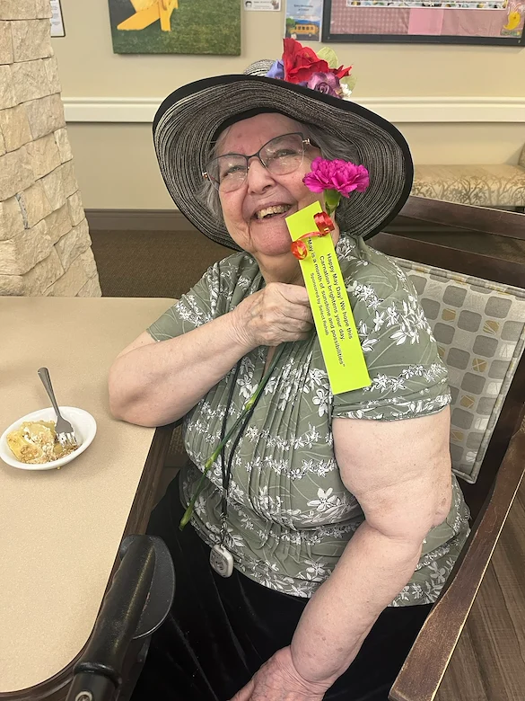 The Village at Keizer Ridge Assisted Living and Memory Care smiling resident with May Day suprise