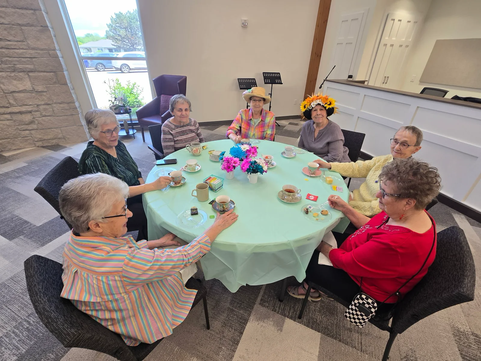 Kidron Bethel Village senior living community and continuing care retirement community (CCRC) offering independent living, assisted living, and respite care in North Newton, KS, ladies celebrating at a community Mother's Day event